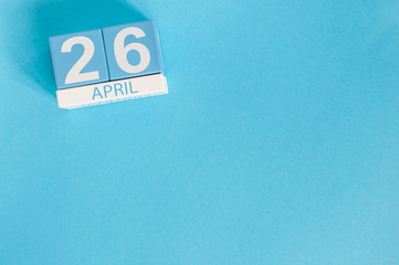 April 26th. Image of april 26 wooden color calendar on blue background.  Spring day, empty space for text