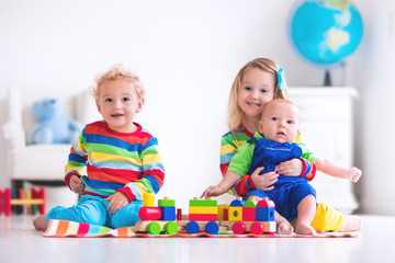 Fototapeta na wymiar Kids playing with wooden toy train