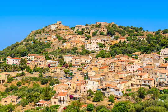 View of Corbara village with stone houses built in traditional Corsican style on top of a hill, France