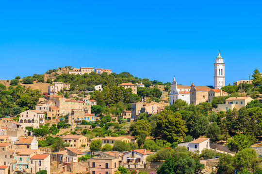 View of Corbara village with stone houses built in traditional Corsican style on top of a hill, France