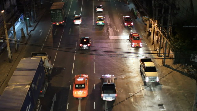 BANGKOK, THAILAND - Aerial view on road. Road traffic in night from high above. Cars and colorful taxi.