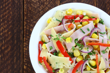 Salad with ham, paprika, corn,cheese and red onion
