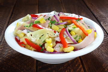 Salad with ham, paprika, corn,cheese and red onion