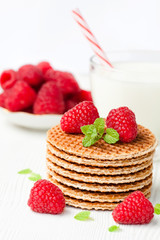 Stack  of Dutch caramel waffles with fresh raspberry and cup of