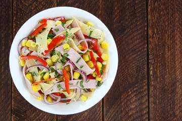 Salad with ham, paprika, corn,cheese and red onion