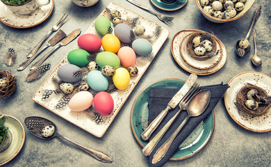 Table setting decoration colorful eggs. Easter dinner vintage
