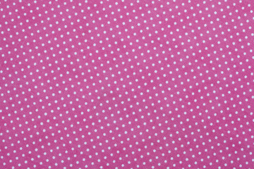 Pink fabric background with polka dots