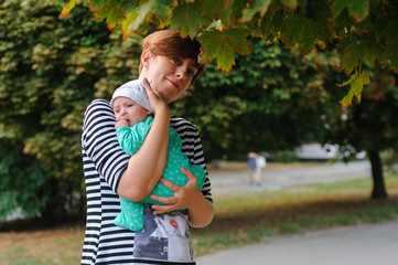 Fototapeta premium Mother with newborn daughter in park
