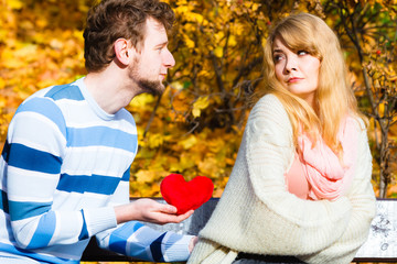 Fototapeta premium Man confess love to girl on bench in park.