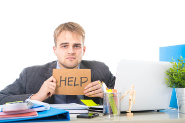 young desperate businessman holding help sign looking worried suffering work stress at computer desk