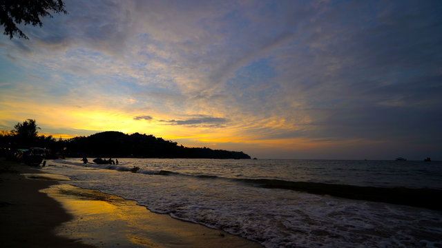 Beautiful  Andaman Sea Water  Waves on the peaceful Gold Sea Sunset. Mountains on the horizon.