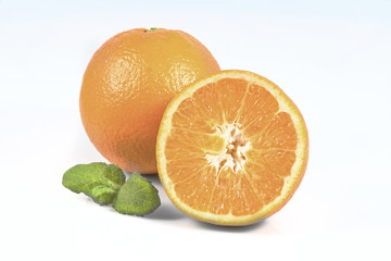 Oranges.One and half of orange fruits with leaf of mint isolated on white background