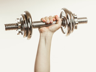Fototapeta na wymiar Closeup arm strong human lifting dumbbells weights