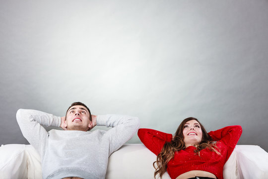 Happy Couple Relaxing Resting On Couch At Home.