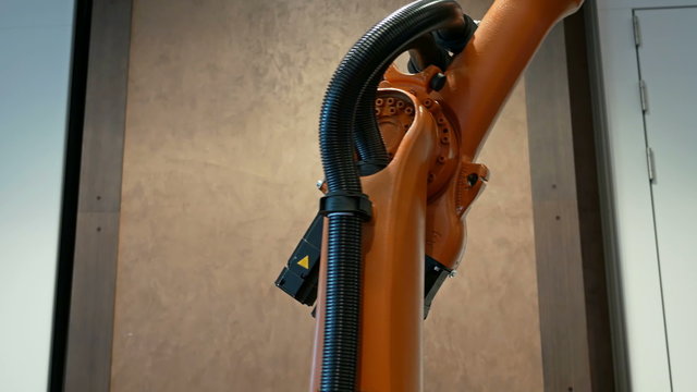 Industrial robotics robot arm for welding and assembling with three dimensional 3d freedom movement. Modern technology 4K UHD video footage.