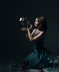 Obraz premium Beautiful fashion girl with butterflies in clear glass cans