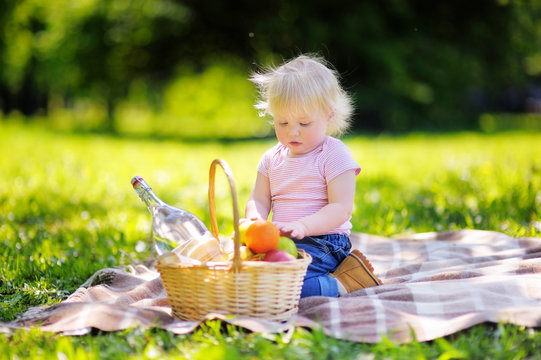 Toddler boy having a picnic in park