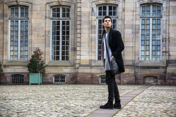 Young man at historic building in Strasbourg, France