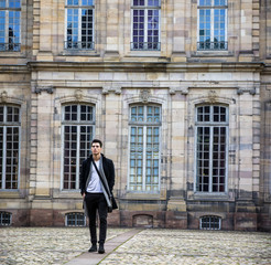 Fototapeta na wymiar Young man at historic building in Strasbourg, France