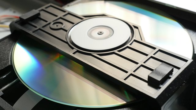 Compact disc mechanism reading sequence start 4K 2160p UltraHD footage - DVD player mechanism close up slow tilt 4K 3840X2160 UHD video 