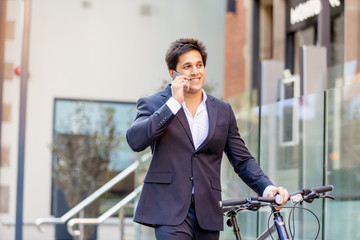 Successful businessman riding bicycle