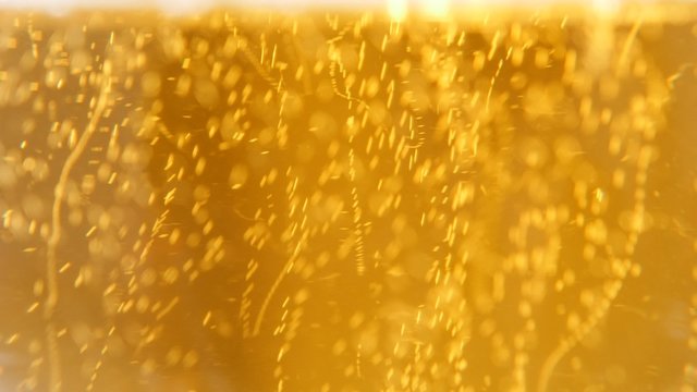 Full glass of beer bubbles close-up 4K 2160p UltraHD footage - Golden beer color and bubbles in the glass 4K 3840X2160 UHD video 