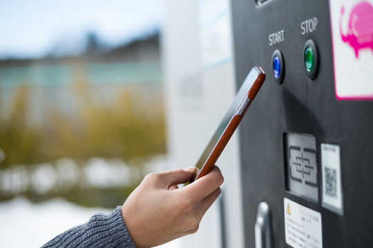 Woman Paying On Charging Car System At Outdoor By NFC