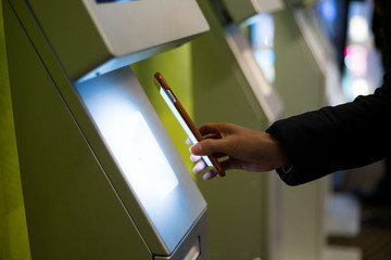 Woman scanning on the payment machine by NFC
