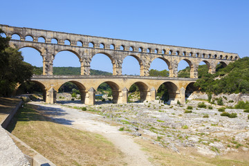 Fototapeta na wymiar Three-tiered aqueduct Pont du Gard was built in Roman times on the river Gardon - France