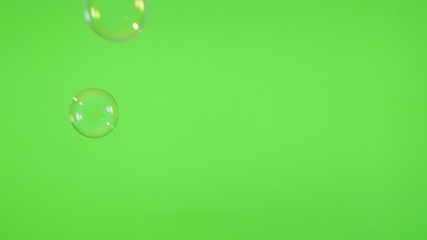 Soap bubbles floating in front of green screen background 4K 3840X2160 UltraHD video - Bubbles of soap falling in front of greenscreen 4K 2160p UHD video 