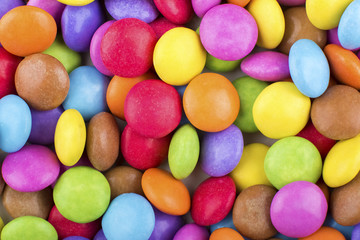 Fototapeta na wymiar Macro detail of pile of coloured chocolate sweets