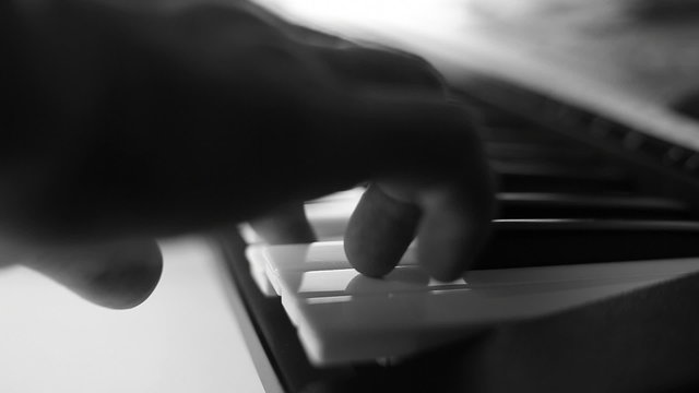 hand tests and playing piano, black .and white