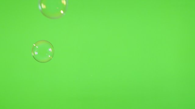 Soap bubbles floating in front of green screen background 4K 3840X2160 UltraHD video - Bubbles of soap falling in front of greenscreen 4K 2160p UHD video 