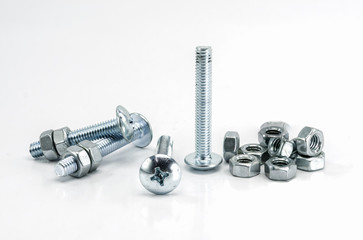 Metal bolts and nuts on white background.