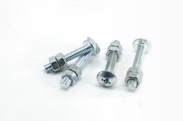 Metal bolts and nuts on white background.