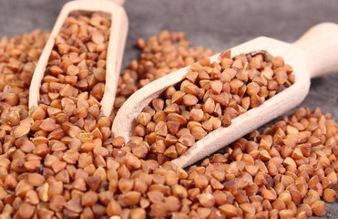 Buckwheat groats with spoon on cement structure