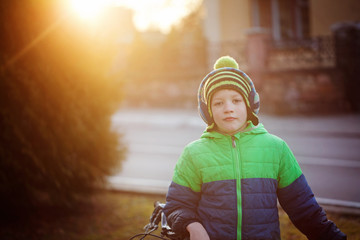 Portrait of a cute boy on bicycle in sunny day