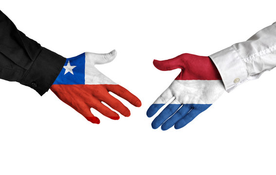 Chile and Netherlands leaders shaking hands on a deal agreement