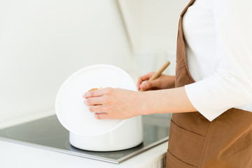 young asian woman cooking image