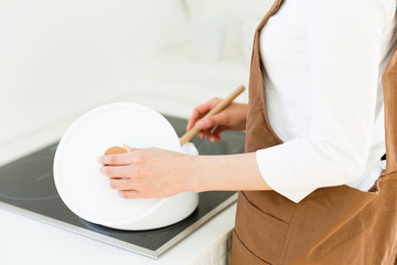 young asian woman cooking image