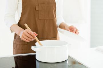 young asian woman cooking image