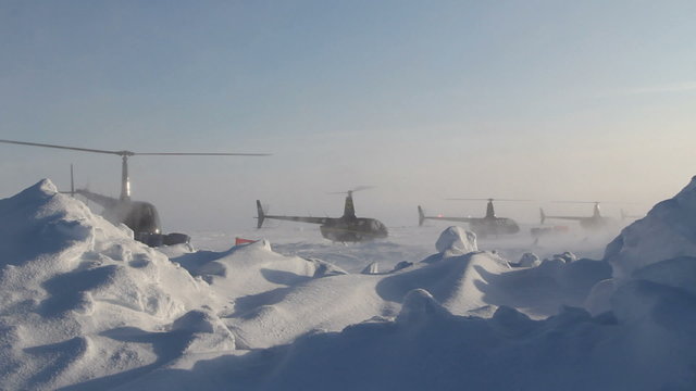 4 helicopters taking off one by one. Russian Ice Camp "BARNEO" at the North Pole. March 2015.
