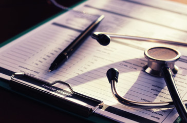 cardiologist stethoscope paper insurance