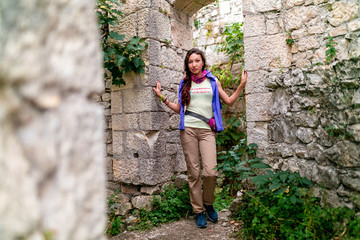 tourist girl looks at Anakopia fortress from the wall of an ancient castle, Abkhazia