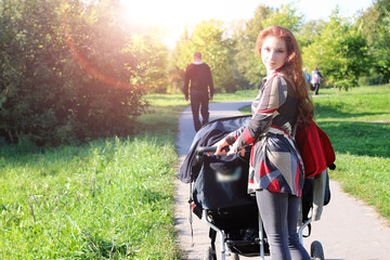 walk women with stroller summer sunlight