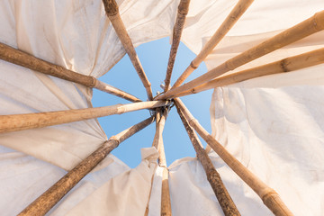 Look up in sky inside a Native American Indian tepee.