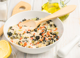 bowl with rice and dried seaweed before being cooked