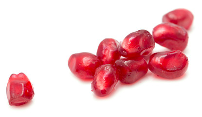 pomegranate seeds on a white background