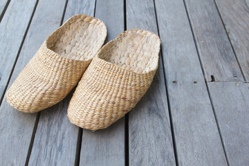 Vintage slippers handmade with bamboo on wood floor