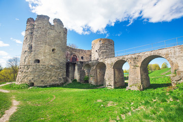 Fototapeta na wymiar Medieval Russian Koporye fortress with two towers and bridge